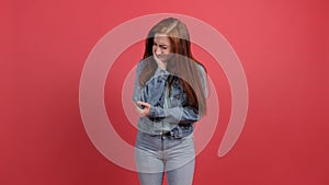 Young woman isolated on red background suffering from severe toothache.