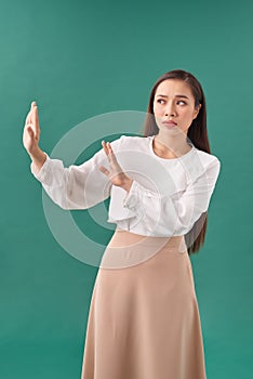 Young woman isolated on turquoise background being shocked due to an imminent danger