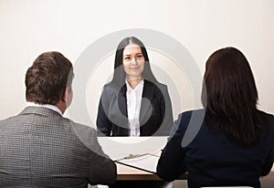 Young woman during job interview and members of managemen