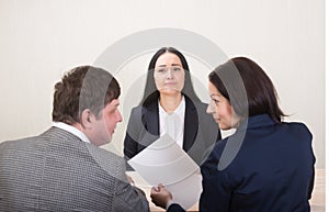 Young woman during job interview and members of managemen.