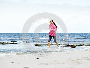 Young Woman Jogging On The Beach