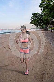 Young woman jogging on beach