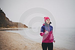 Young woman jogging at the beach