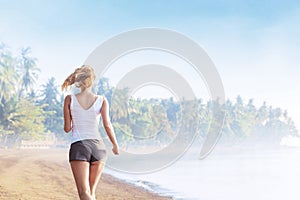 Young woman jogging on the beach