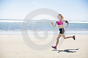 Young woman jogging on the beach in summer day. Athlete runner exercising actively in sunny day