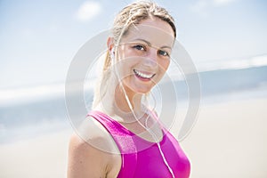 Young woman jogging on the beach in summer day. Athlete runner exercising actively in sunny day