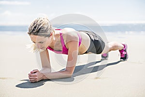 Young woman jogging on the beach in summer day. Athlete runner exercising actively in sunny day