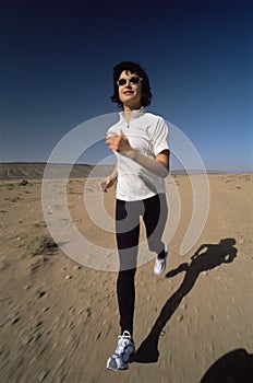 Young woman jogging in desert