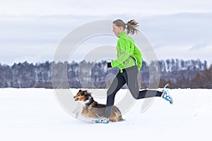 Young woman jogging with a dog