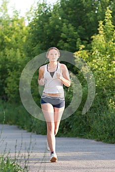 Young woman is jogging in the park