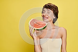 A young woman joyously holding a photo