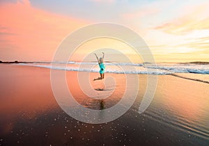 Young woman jumping on the beach on bali in indonesia