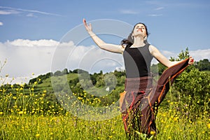 Young woman jumping in a field of flowers