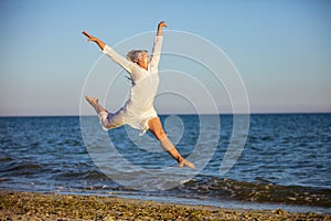 Young woman jumping with joy on beach