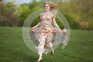 Young woman jumping on meadow