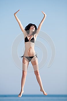 Young woman jumping on open air