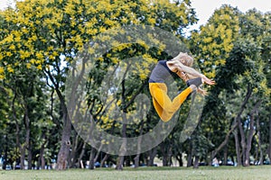 young woman jumping high in the park