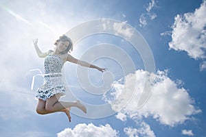Young woman jumping in sky