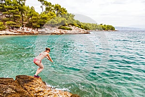 Young woman jumping in the water