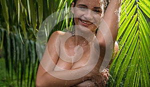 Young woman in jungle during rainy day