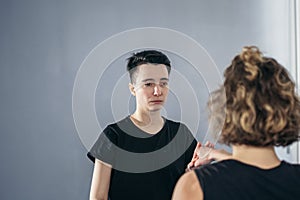 Young woman karate student with her trainer in gym. Taekwondo coach teaching adult woman in personal training. Two women