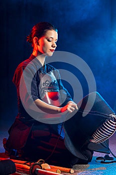 Young woman kendo fighter wear mask helmet on head