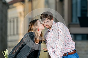 Young woman kisses her boyfriend