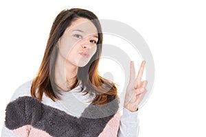Young woman kissing and giving the peace sign