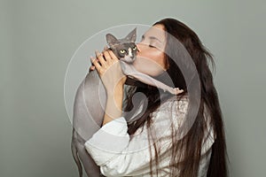 Young woman kissing pet cat