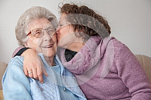 Young woman kissing senior woman