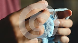 Young woman knits with circular knitting needles