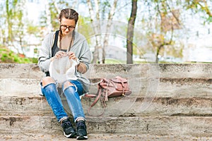 Young woman knits with knitting needles