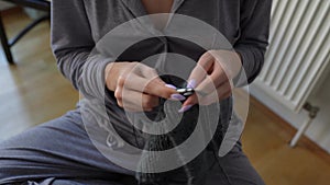 young woman knits wool product