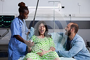 Young woman in labor screaming from contractions
