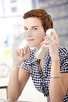 Young woman on landline call photo