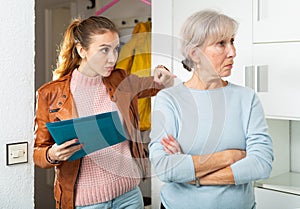 Young woman landlord and senior woman tenant discussing problem