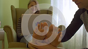 Young woman with laptop in the chair