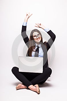 Young woman with laptop computer celebrating success,