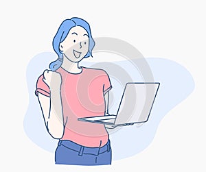 Young woman with a laptop and confidently lifting his fist when analyzing that business grows.