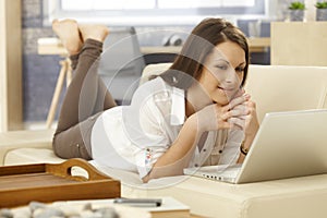 Young woman with laptop at home