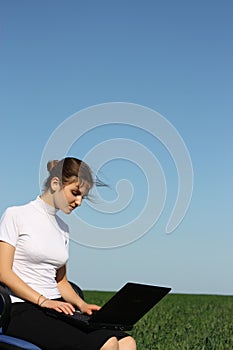 Young woman with laptop outdoor