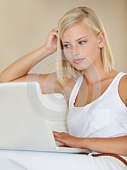 Young woman, laptop and relax on sofa with online streaming service for website, movie or social media. Person watch or
