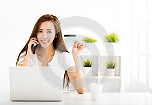 young woman with laptop and showing credit card