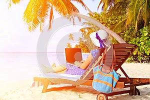 Young woman with laptop on tropical vacation