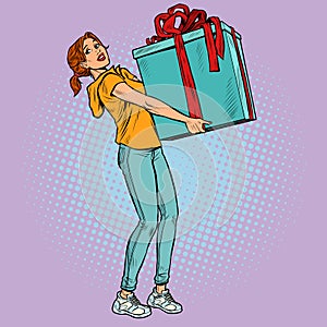 A young woman with a large gift box. Christmas or birthday. Surprise