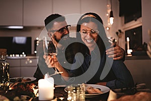 Young woman laughing during a fun dinner party with friends