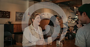 Young woman laughing with her friends in a bar