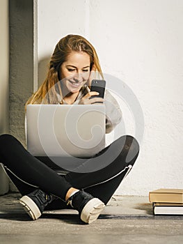 Young woman laughing at her smartphone