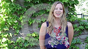 Young Woman Laughing With Ivy Background