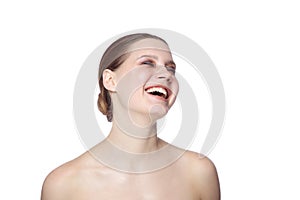 Young woman laughing out loud, over white background